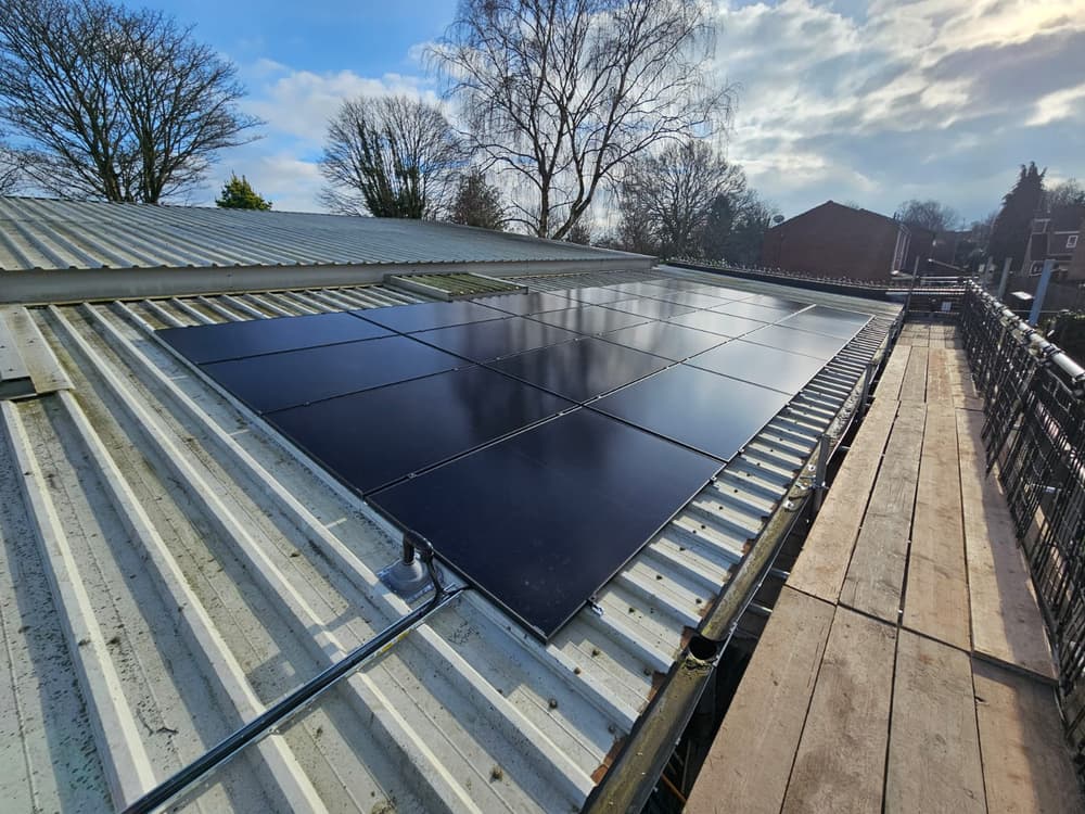 All-black array on the clubhouse roof under a clear sky