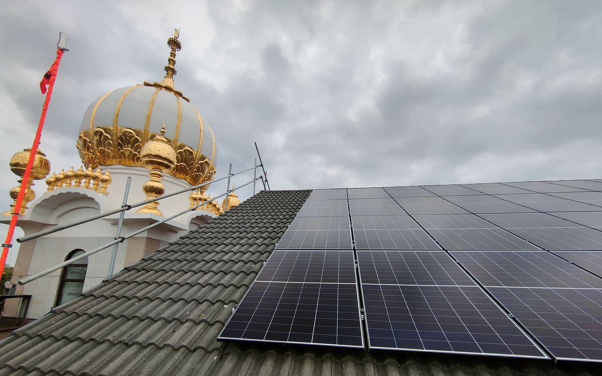 Solar panels on the Guru Nanak Gurdwara Smethwick roof with the golden domes behind